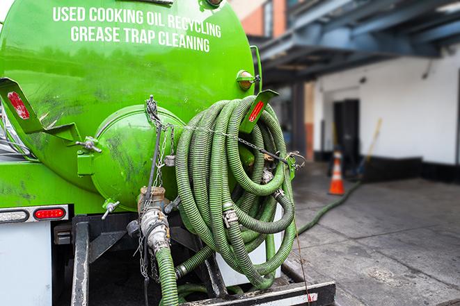 grease trap pumping truck in action in Edmond, OK